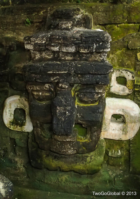 A large stucco mask adorning the substructure of Temple 33