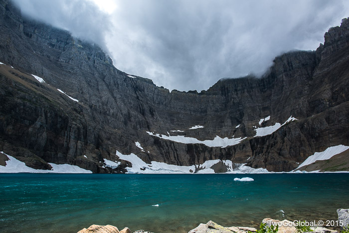 An overcast Iceberg Lake, complete with a lone iceberg
