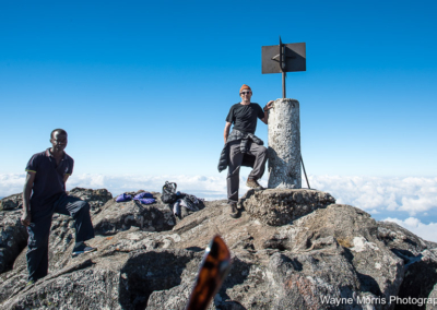 Standing atop the 9,849 ft summit of Sapitwa Peak with our guide Vincent