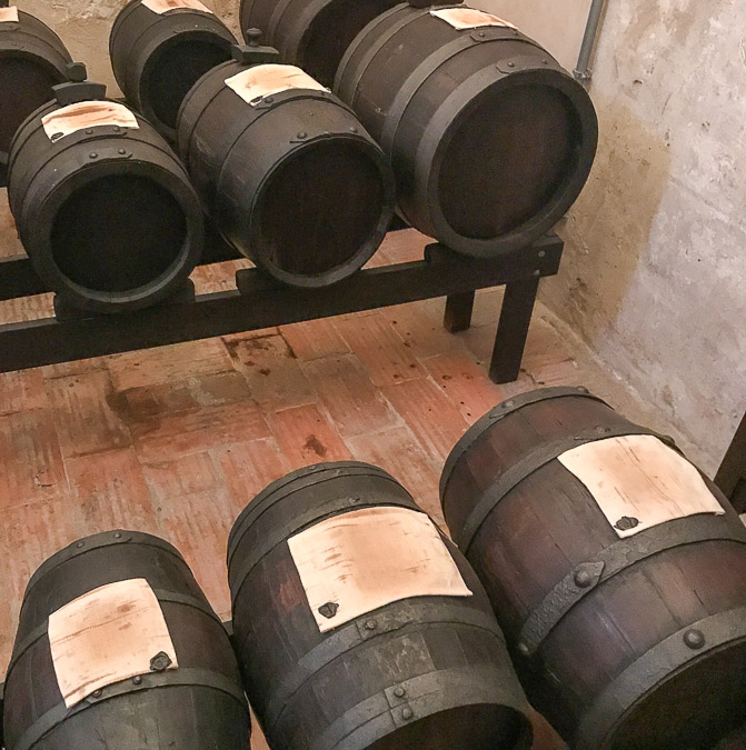 Batteries of balsamic vinegar, curing in different wooden caskets